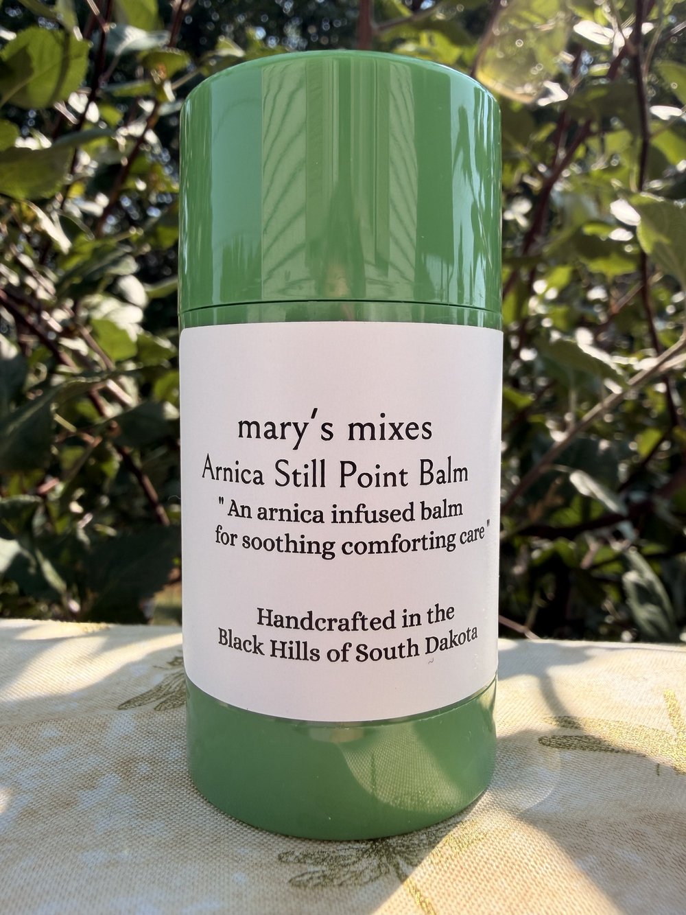Mary’s Mixes Arnica Still Point Balm photographed in the garden